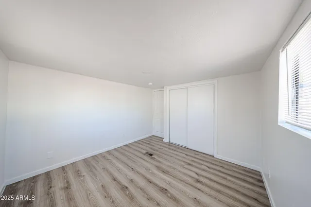 a view of a room with wooden floor