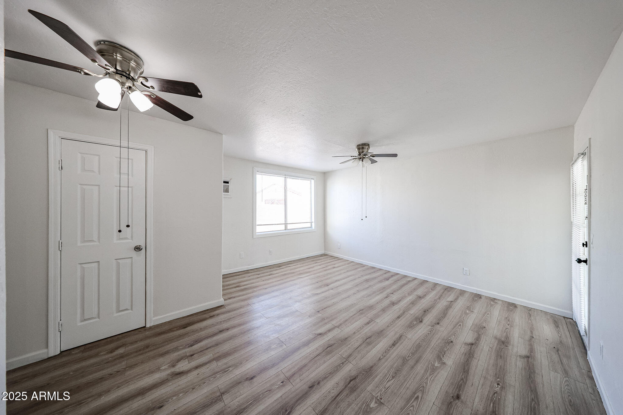 2839 East Marco Polo Road Phoenix, AZ 85050 - Photo 23 of 43 wooden floor in an empty room with a window