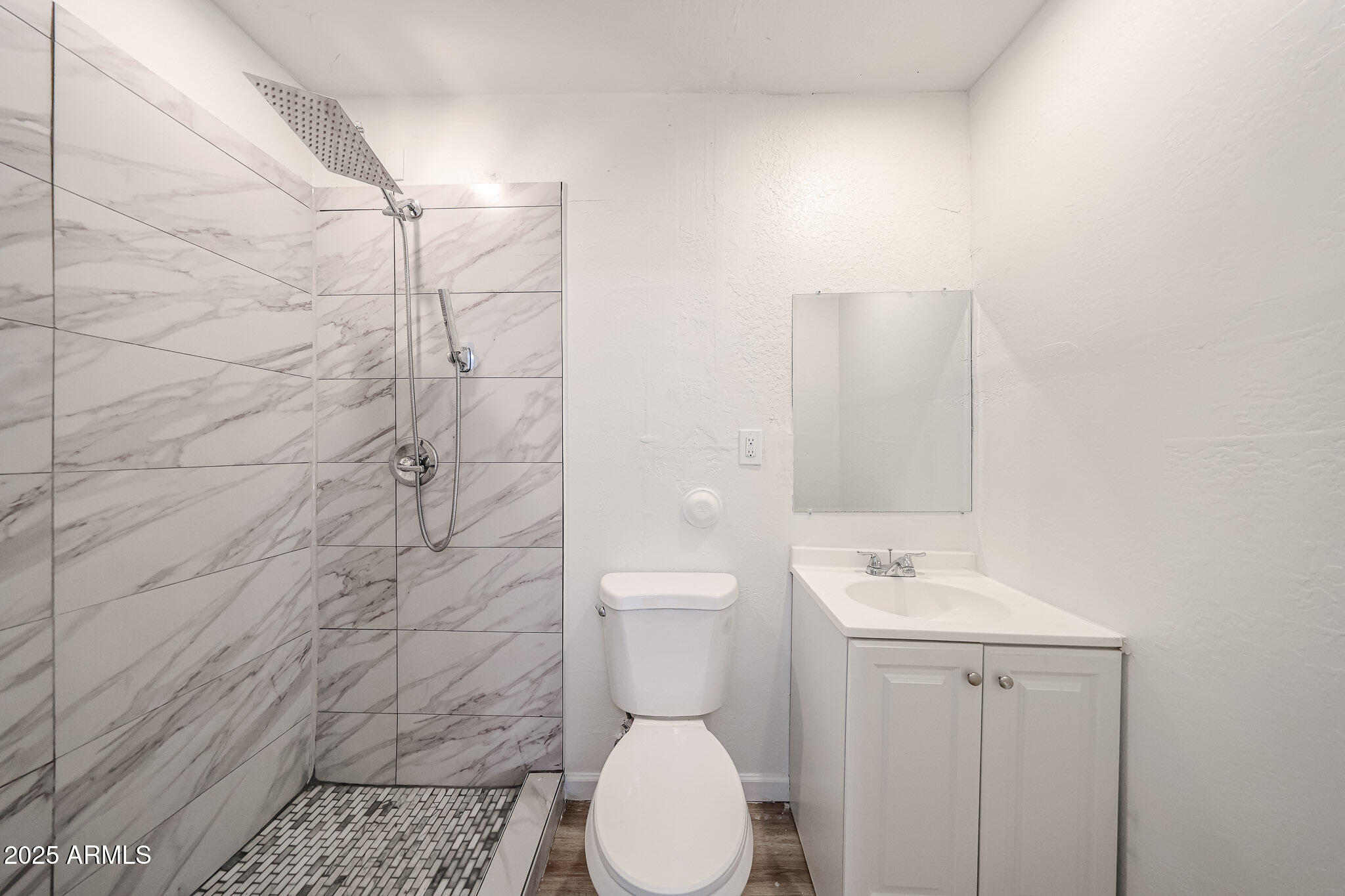 2839 East Marco Polo Road Phoenix, AZ 85050 - Photo 24 of 43 a bathroom with a toilet a sink and shower