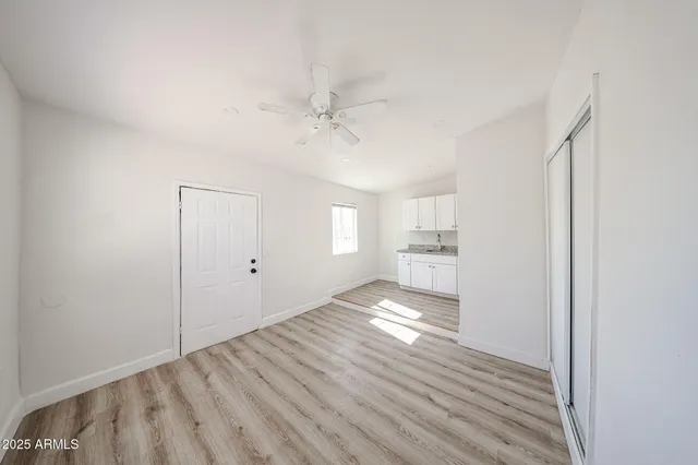 a view of a kitchen with a sink wooden floor and a bathroom