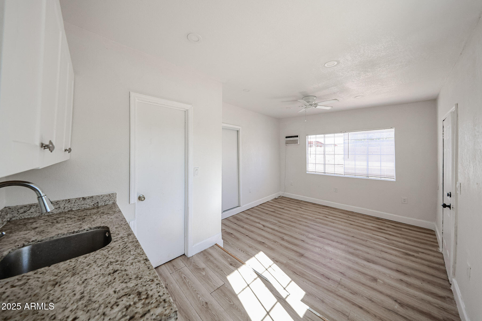 2839 East Marco Polo Road Phoenix, AZ 85050 - Photo 27 of 43 a view of a kitchen with a sink wooden floor and a bathroom