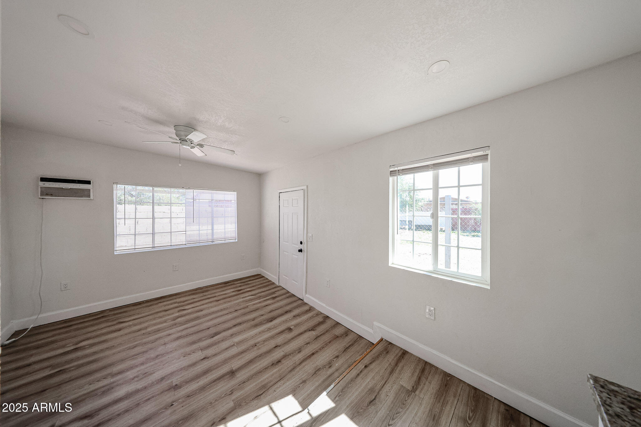 2839 East Marco Polo Road Phoenix, AZ 85050 - Photo 30 of 43 an empty room with wooden floor and windows