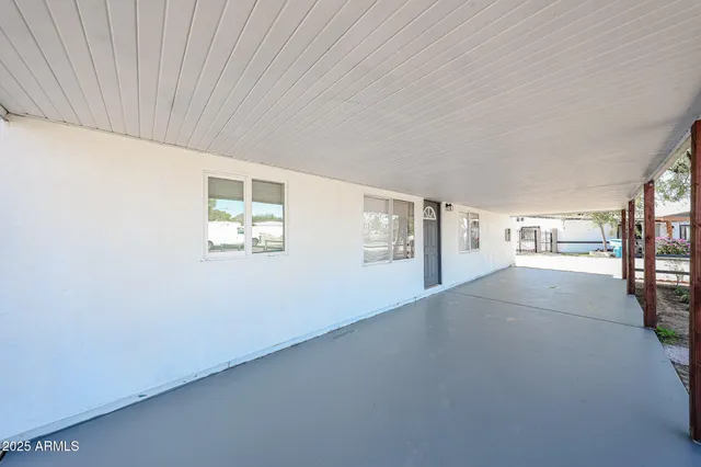 a view of a balcony with wooden floor and fence