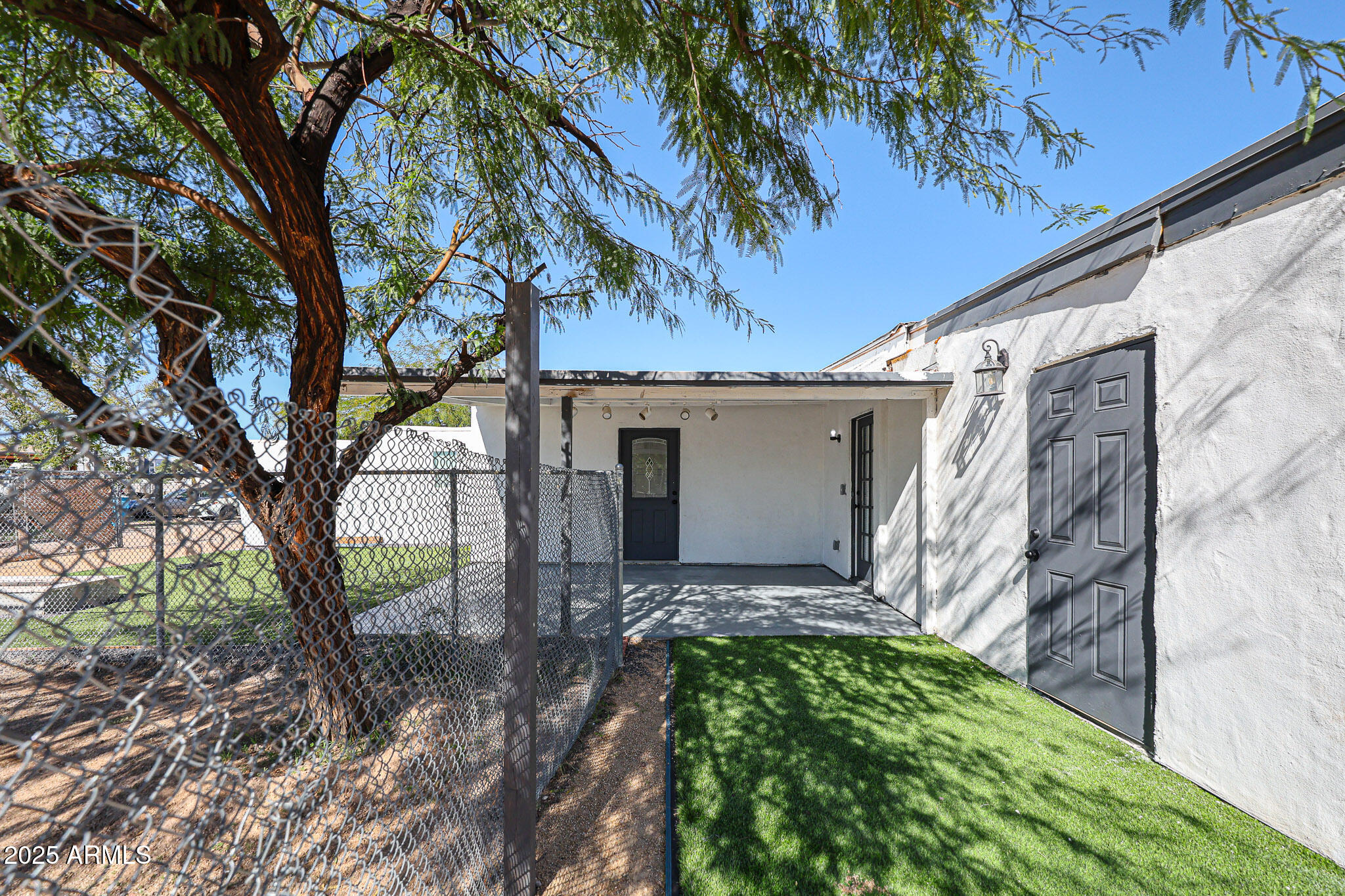 2839 East Marco Polo Road Phoenix, AZ 85050 - Photo 42 of 43 a view of a house with a tree in a yard