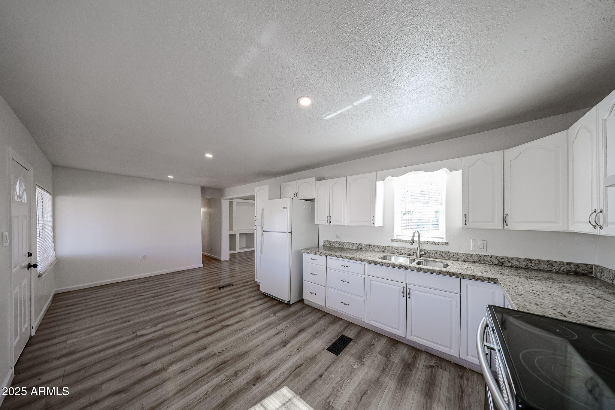 2839 East Marco Polo Road Phoenix, AZ 85050 - Photo 7 of 43 a kitchen with granite countertop a sink window and cabinets