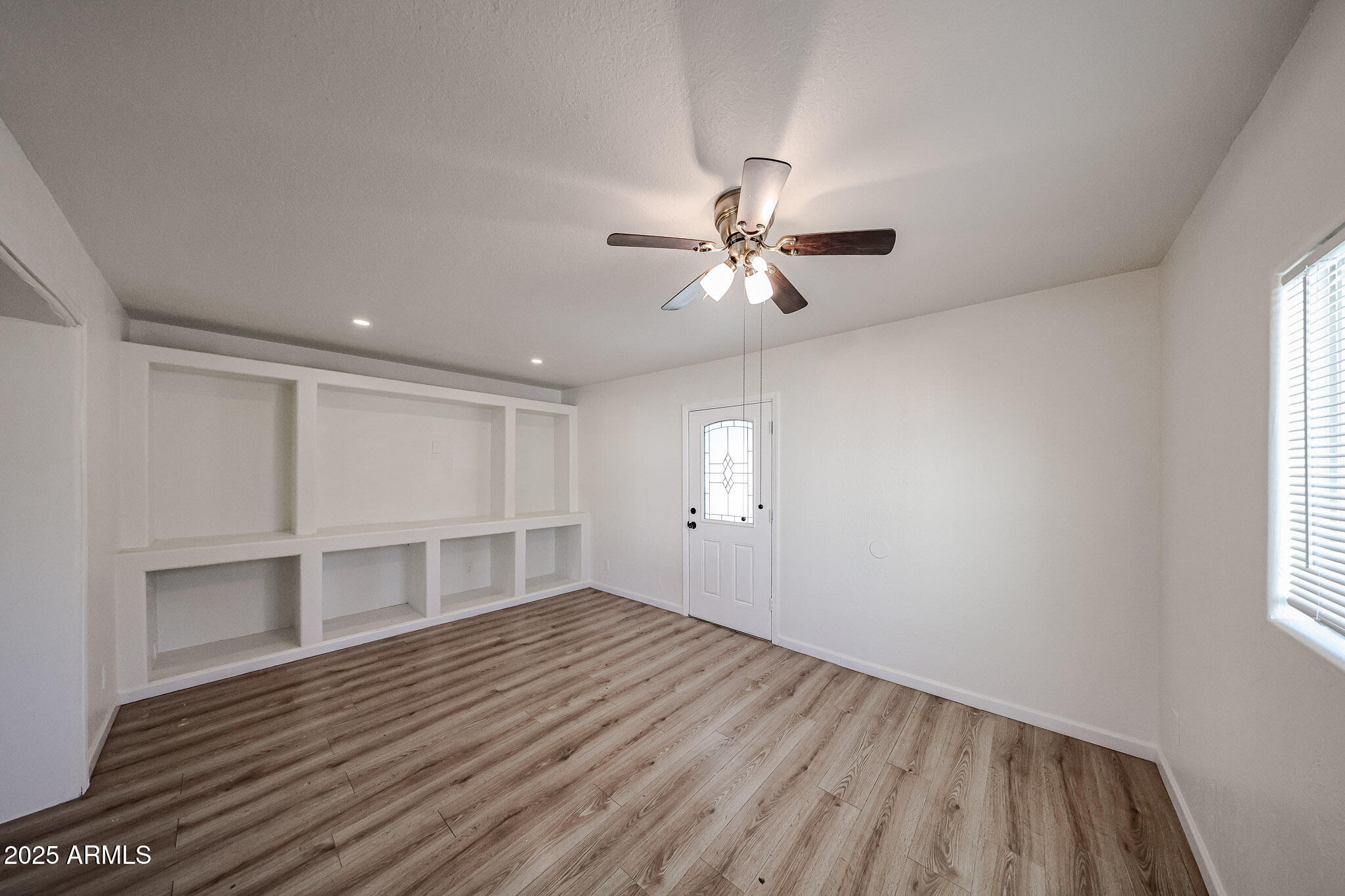 2839 East Marco Polo Road Phoenix, AZ 85050 - Photo 10 of 43 an empty room with wooden floor and windows