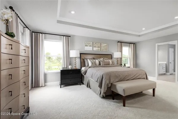 a spacious bedroom with a bed and a window