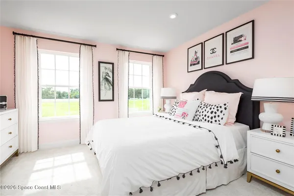 a bedroom with a bed and a large window