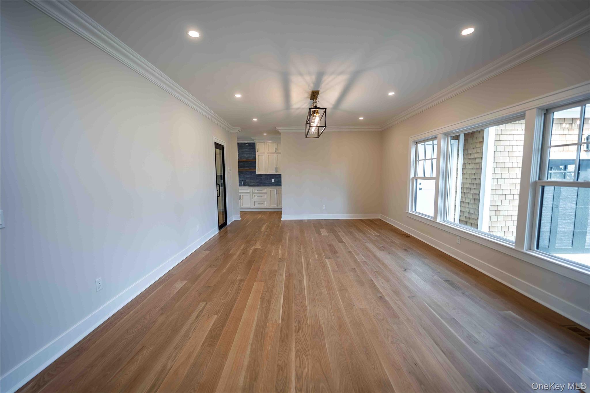 106 Cove Road Northport, NY 11768 - Photo 17 of 49 wooden floor in an empty room with a window