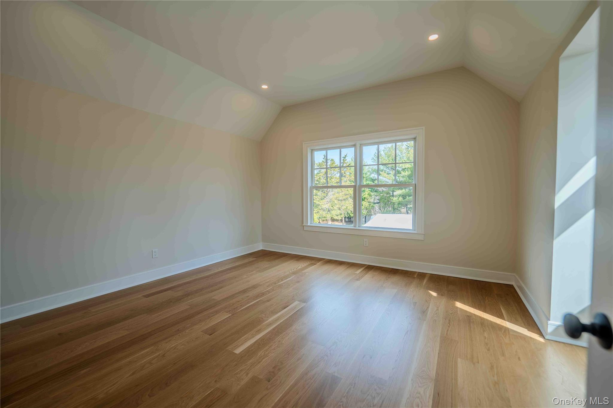 106 Cove Road Northport, NY 11768 - Photo 31 of 49 an empty room with wooden floor and windows