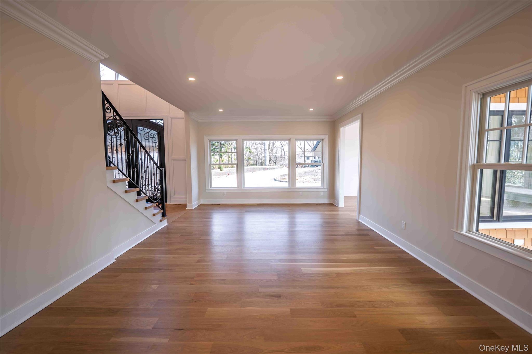 106 Cove Road Northport, NY 11768 - Photo 8 of 49 an empty room with wooden floor and windows