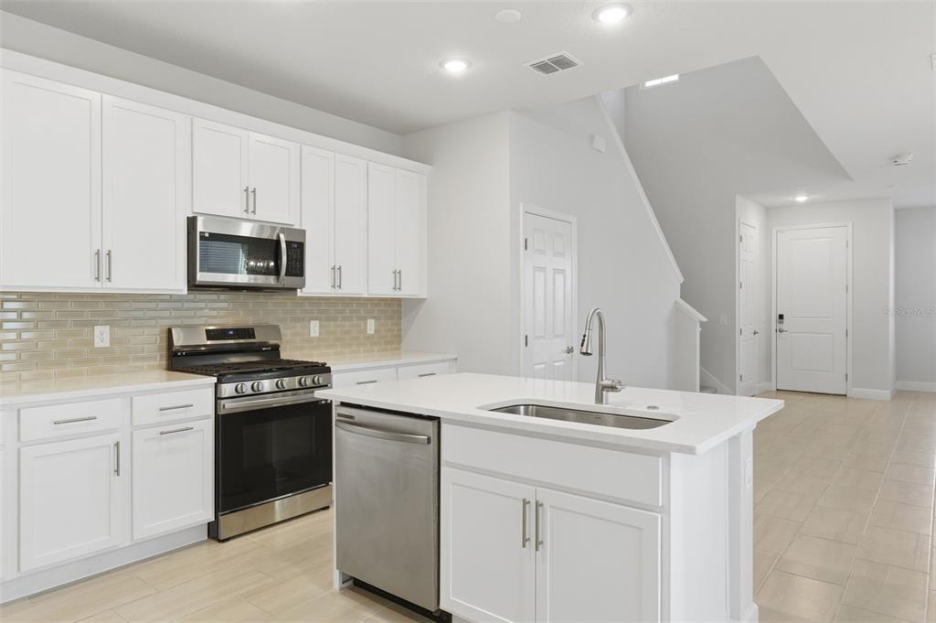 269 Platform Lane DeBary, FL 32713 - Photo 14 of 41 a kitchen with stainless steel appliances granite countertop a sink stove and microwave