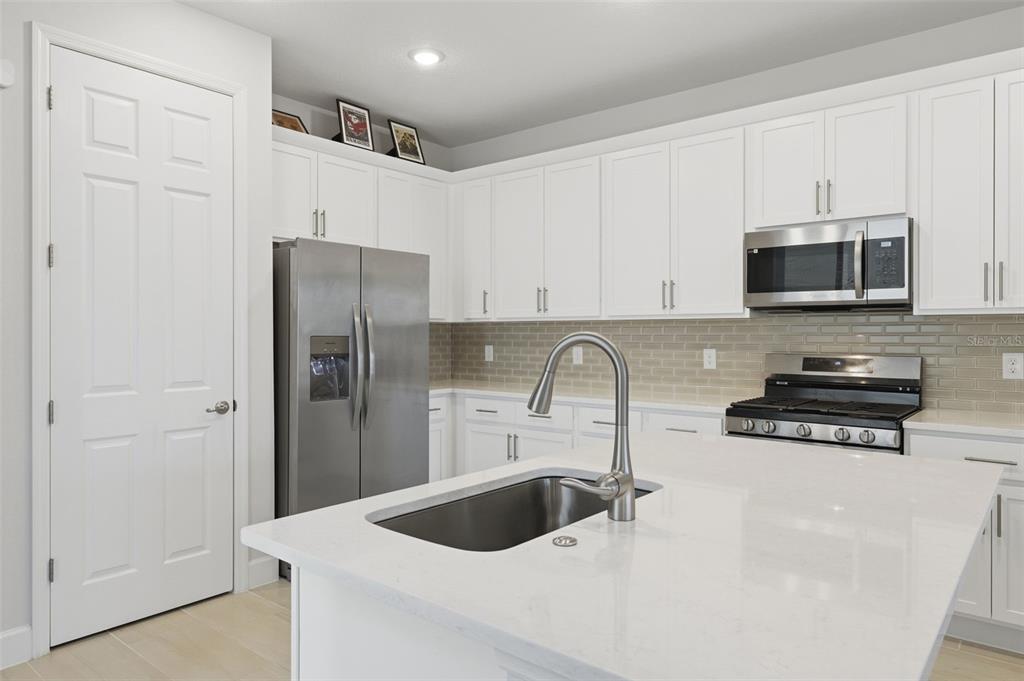 269 Platform Lane DeBary, FL 32713 - Photo 15 of 41 a kitchen with stainless steel appliances a refrigerator a sink a stove a microwave and cabinets