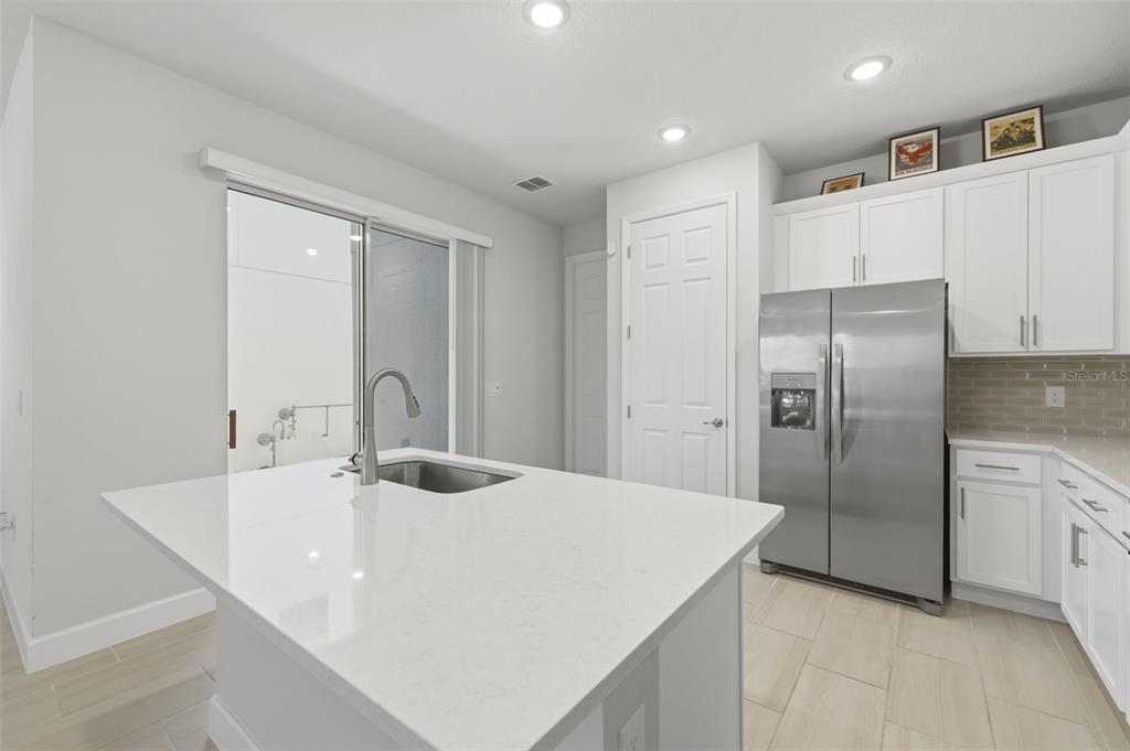 269 Platform Lane DeBary, FL 32713 - Photo 16 of 41 a kitchen with kitchen island a counter top space cabinets and stainless steel appliances