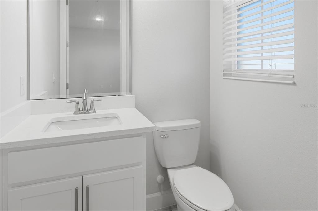 269 Platform Lane DeBary, FL 32713 - Photo 18 of 41 a bathroom with a toilet sink vanity and mirror