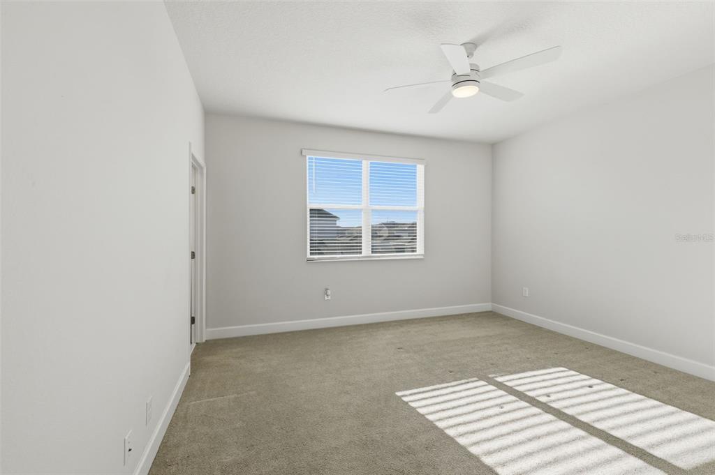 269 Platform Lane DeBary, FL 32713 - Photo 23 of 41 an empty room with windows and ceiling fan