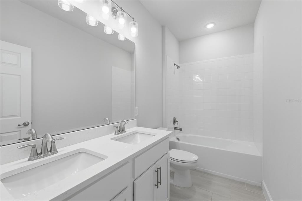 269 Platform Lane DeBary, FL 32713 - Photo 30 of 41 a bathroom with a granite countertop sink a toilet and a mirror