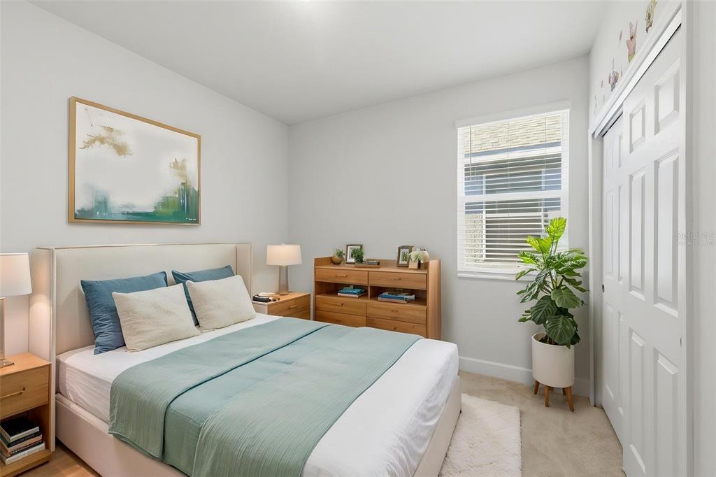 269 Platform Lane DeBary, FL 32713 - Photo 9 of 41 a bedroom with a bed and a potted plant