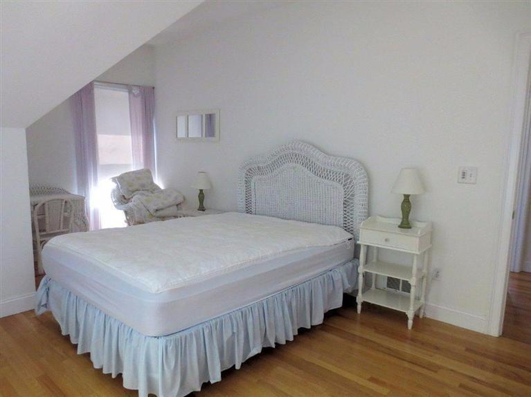41 Chapoquoit Road Falmouth, MA 02540 - Photo 11 of 19 a bedroom with a bed and a table