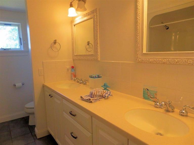41 Chapoquoit Road Falmouth, MA 02540 - Photo 12 of 19 a bathroom with a sink and a mirror