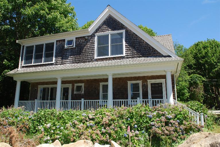 41 Chapoquoit Road Falmouth, MA 02540 - Photo 2 of 19 a view of a brick house with large windows