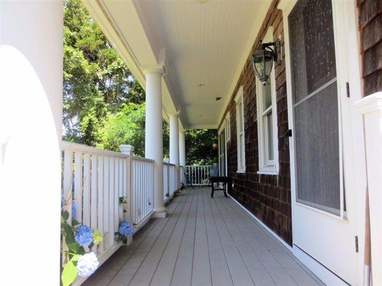 41 Chapoquoit Road Falmouth, MA 02540 - Photo 3 of 19 a balcony with wooden floor stairs and wooden floor