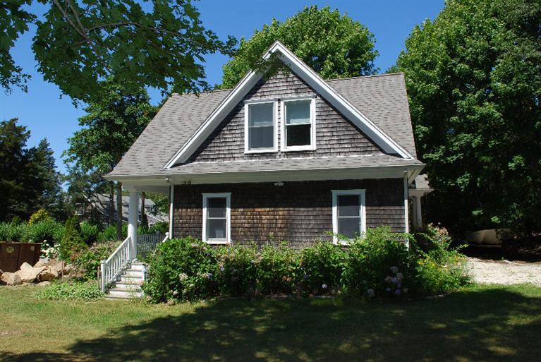 41 Chapoquoit Road Falmouth, MA 02540 - Photo 4 of 19 a front view of a house with a yard and green space