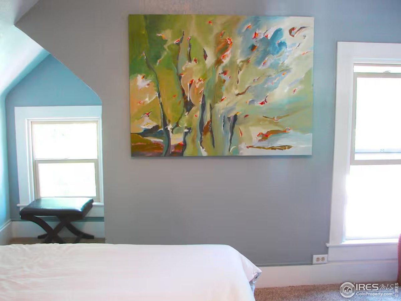 636 Marine Street Boulder, CO 80302 - Photo 22 of 46 a bedroom with a bed painting on the wall and a window