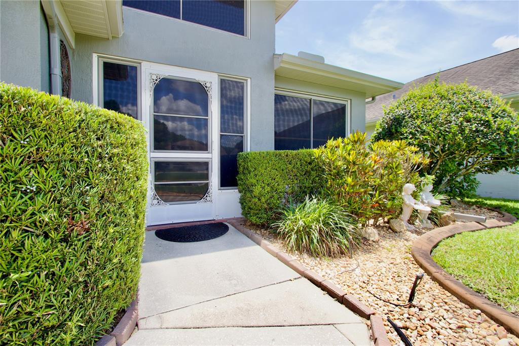 7842 Tenby Court New Port Richey, FL 34655 - Photo 21 of 27 a front view of a house with garden