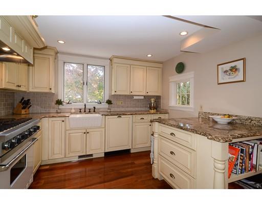33 Cottage Street Wellesley, MA 02482 - Photo 6 of 23 a kitchen with a sink window and cabinets