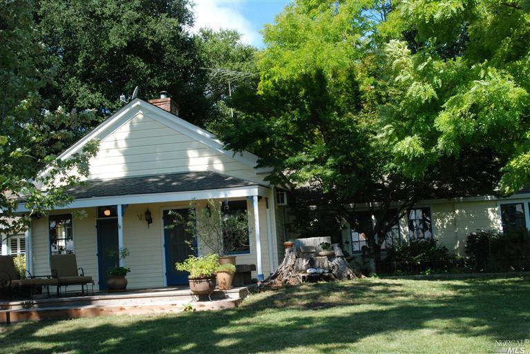 a front view of a house with a yard table and chairs