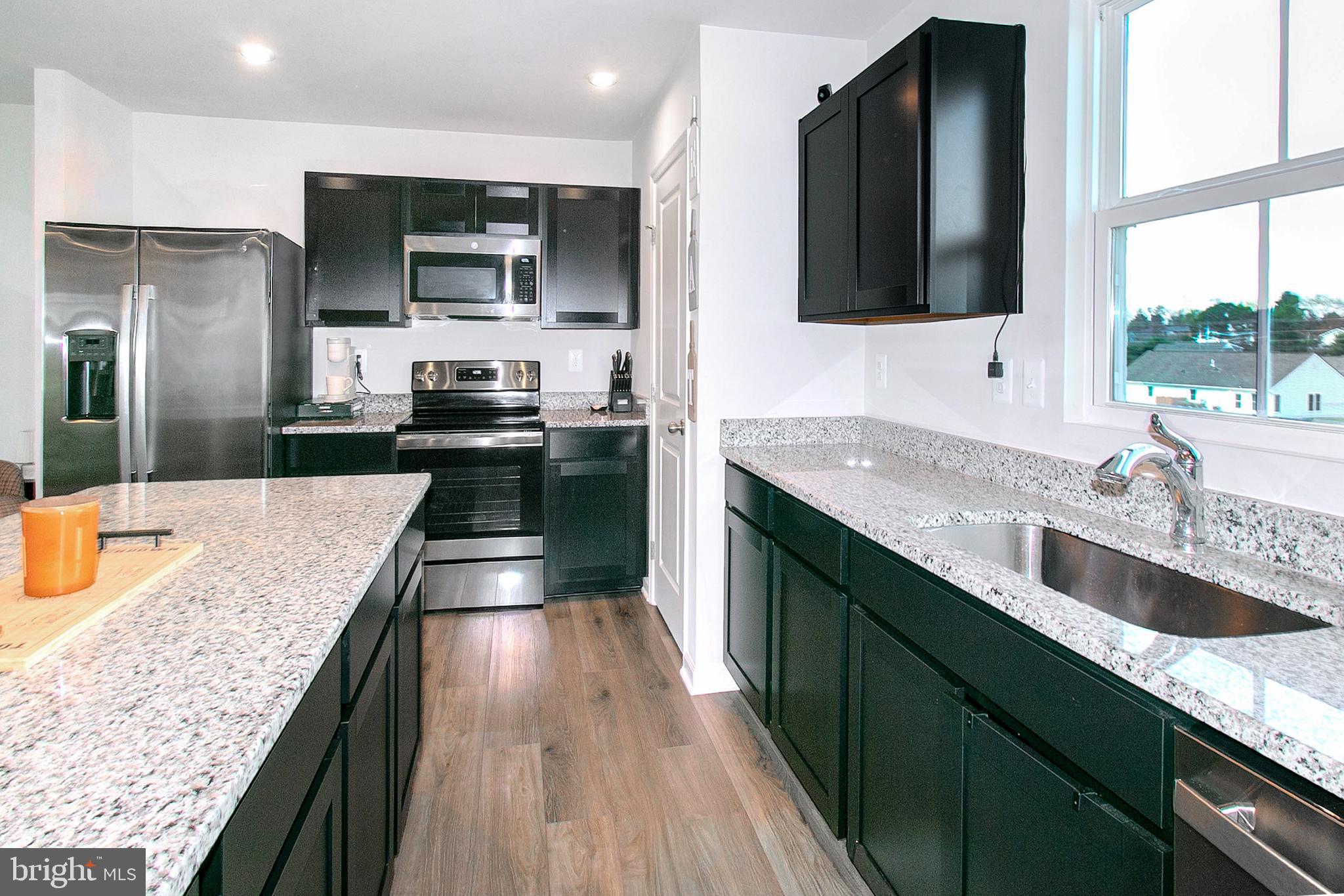 2616 High Point Drive Culpeper, VA 22701 - Photo 11 of 40 a kitchen with stainless steel appliances granite countertop a sink a stove and a wooden floors