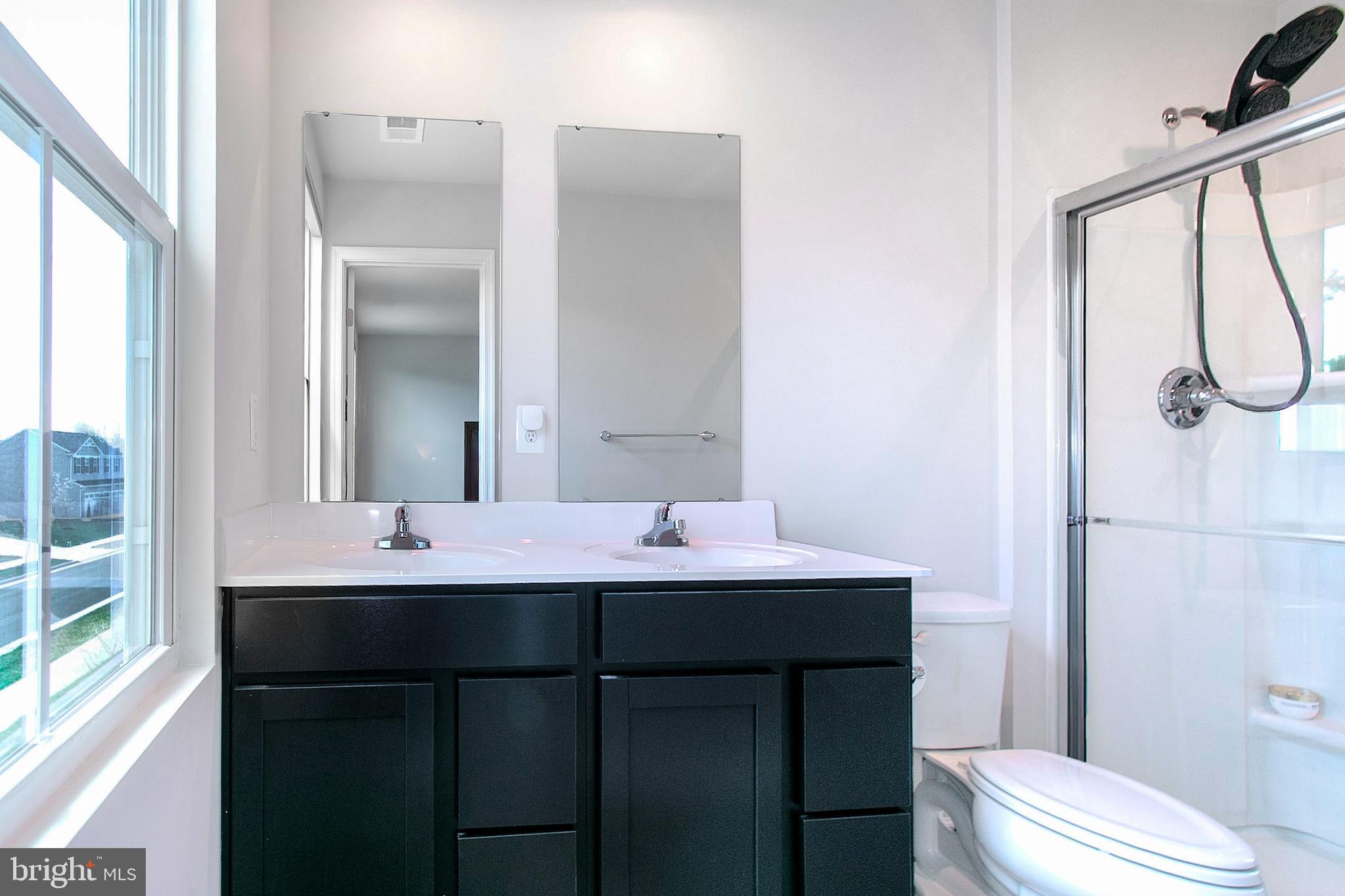 2616 High Point Drive Culpeper, VA 22701 - Photo 26 of 40 a bathroom with a sink and a mirror