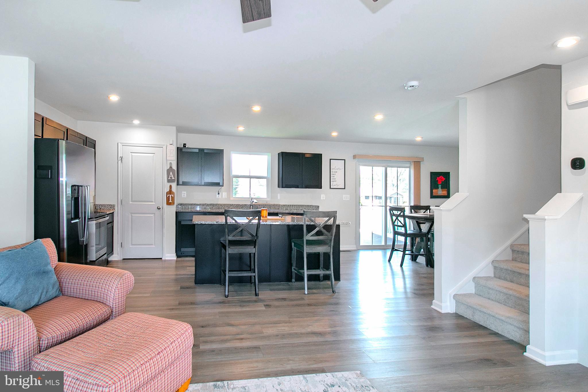2616 High Point Drive Culpeper, VA 22701 - Photo 8 of 40 a living room kitchen with furniture and a wooden floor