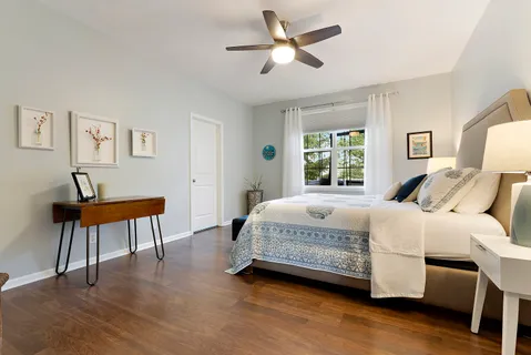 a bedroom with a bed a table and chair