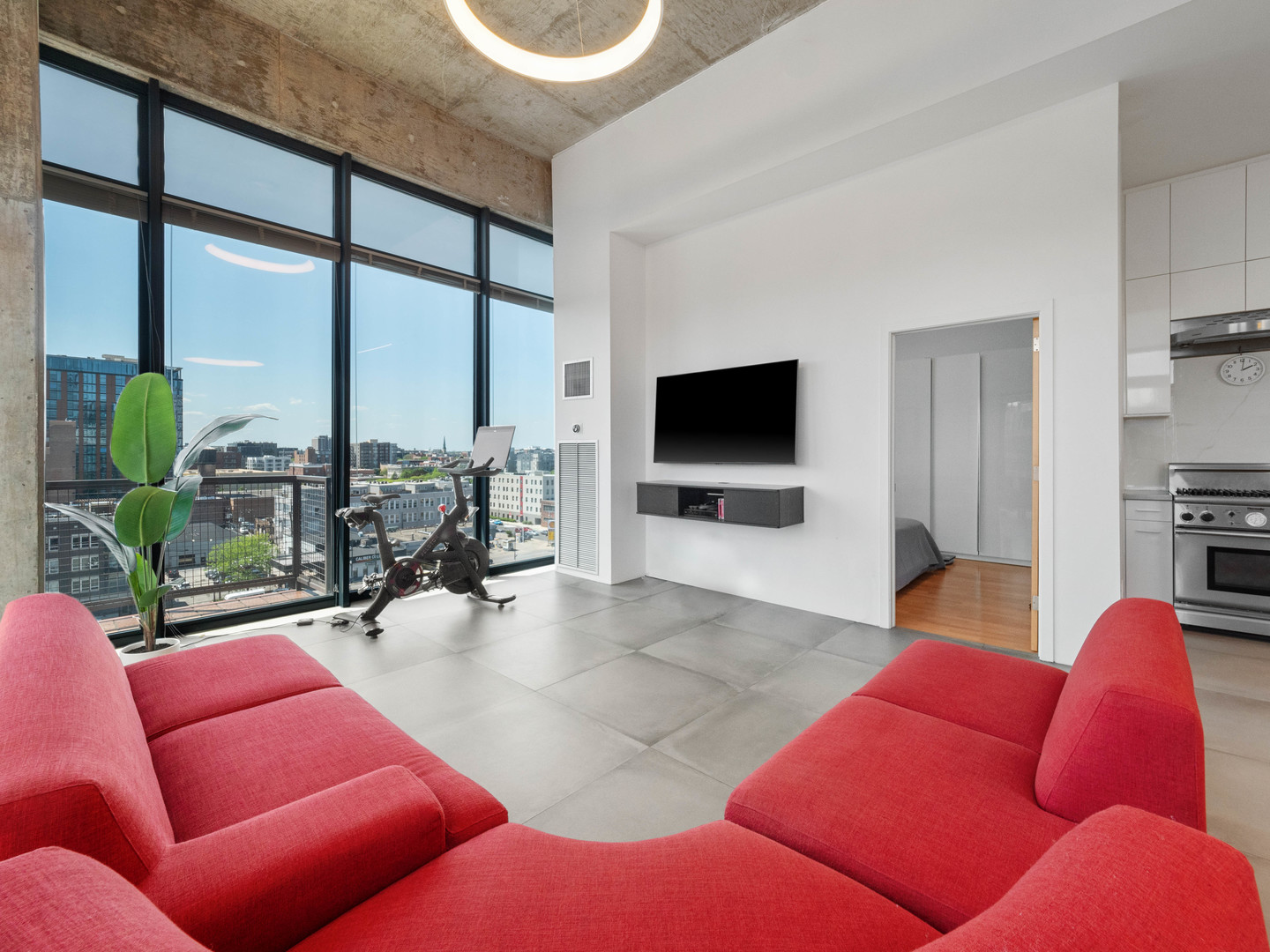 321 South Sangamon Street, Unit 905 Chicago, IL 60607 - Photo 17 of 36 a living room with furniture a floor to ceiling window and a flat screen tv