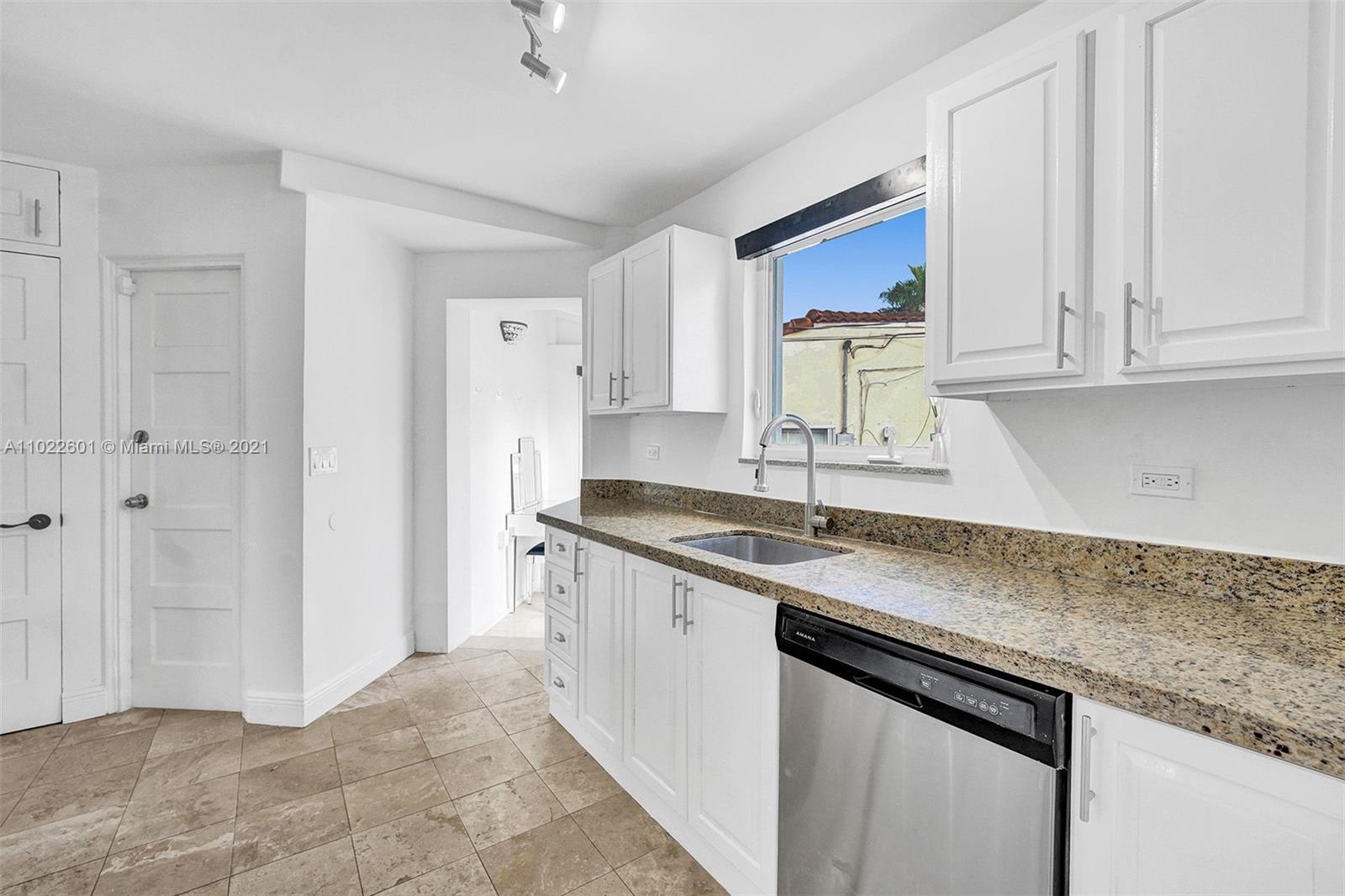 4717 Alton Road Miami Beach, FL 33140 - Photo 12 of 59 a kitchen with granite countertop a sink and cabinets