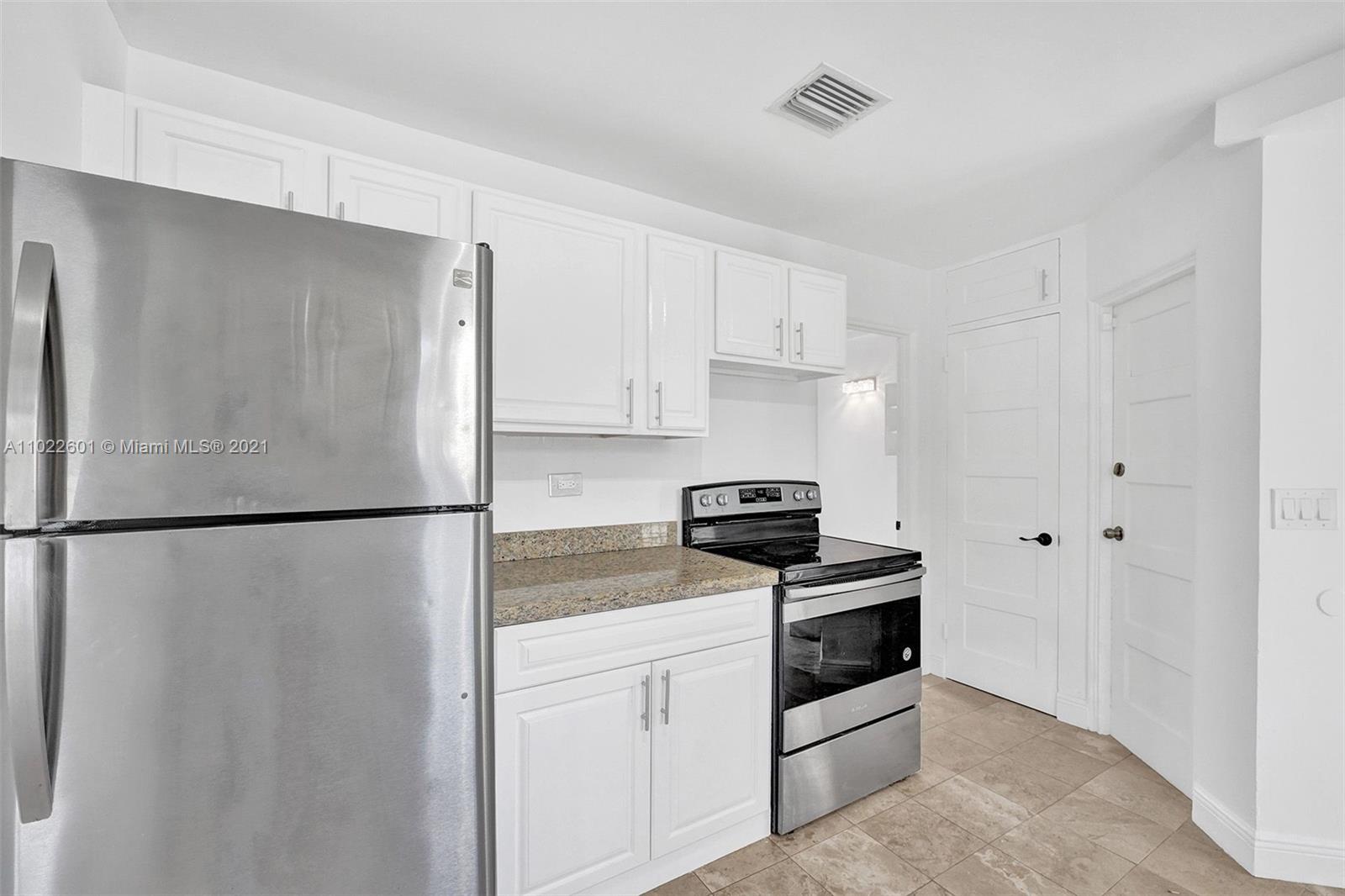 4717 Alton Road Miami Beach, FL 33140 - Photo 15 of 59 a white refrigerator freezer sitting in a kitchen