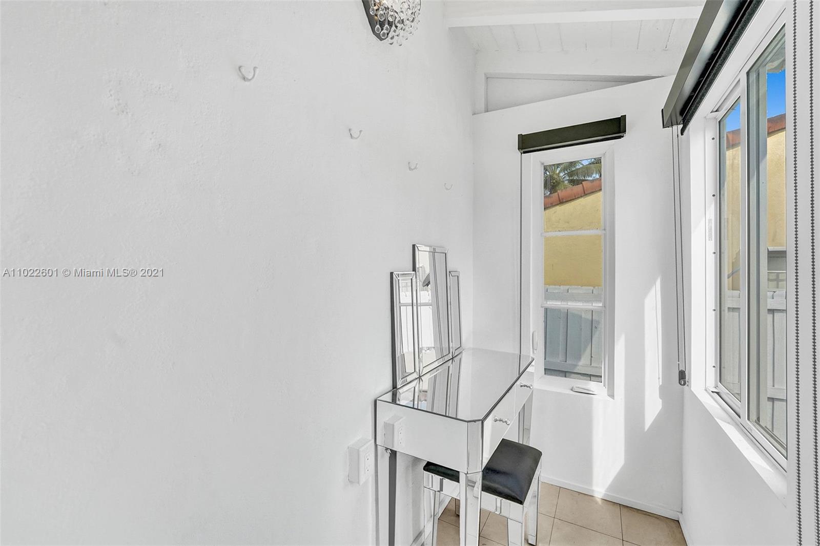 4717 Alton Road Miami Beach, FL 33140 - Photo 18 of 59 a view of room with wooden floor and chair