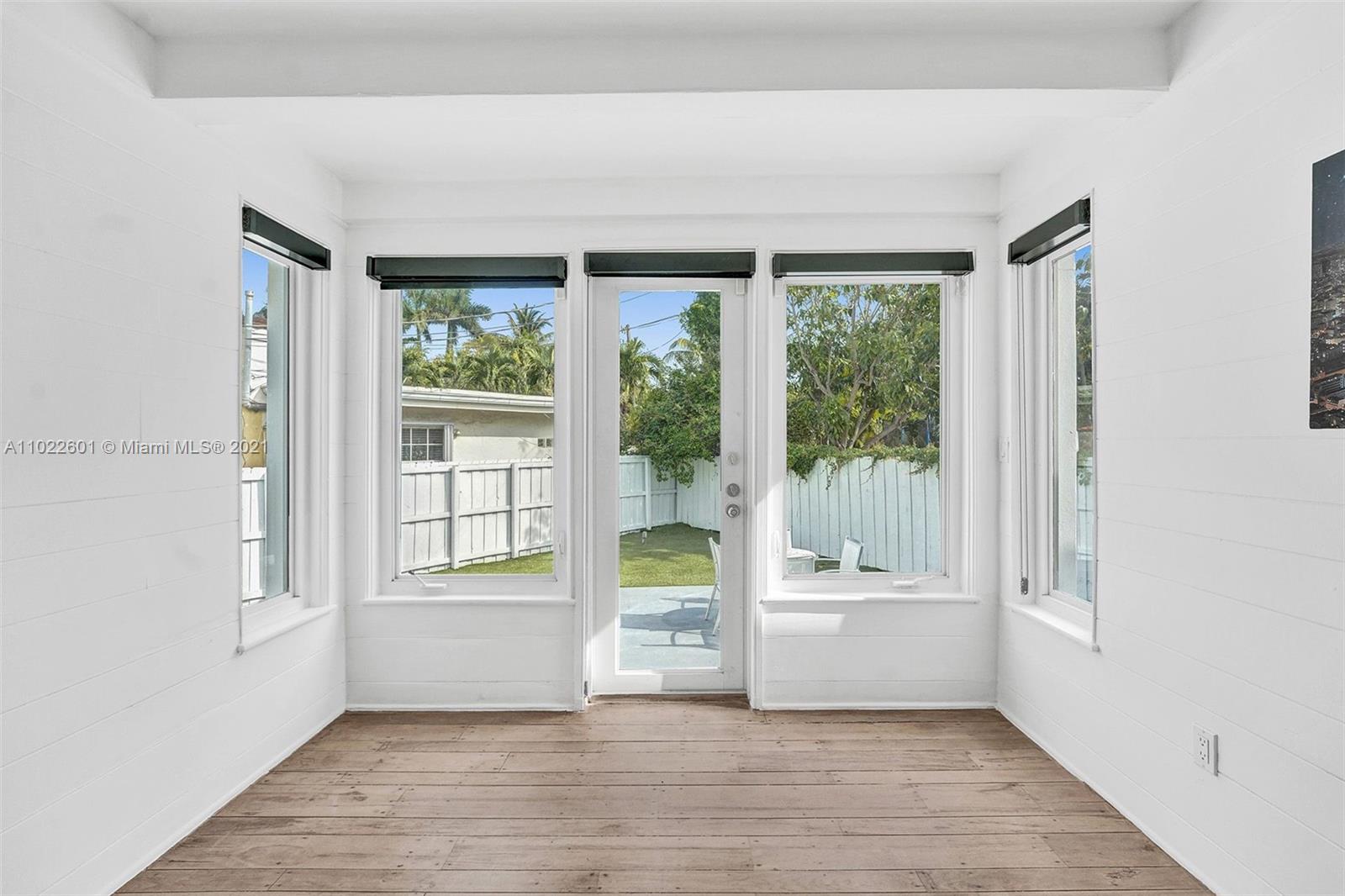 4717 Alton Road Miami Beach, FL 33140 - Photo 37 of 59 a view of an empty room with a window and wooden floor