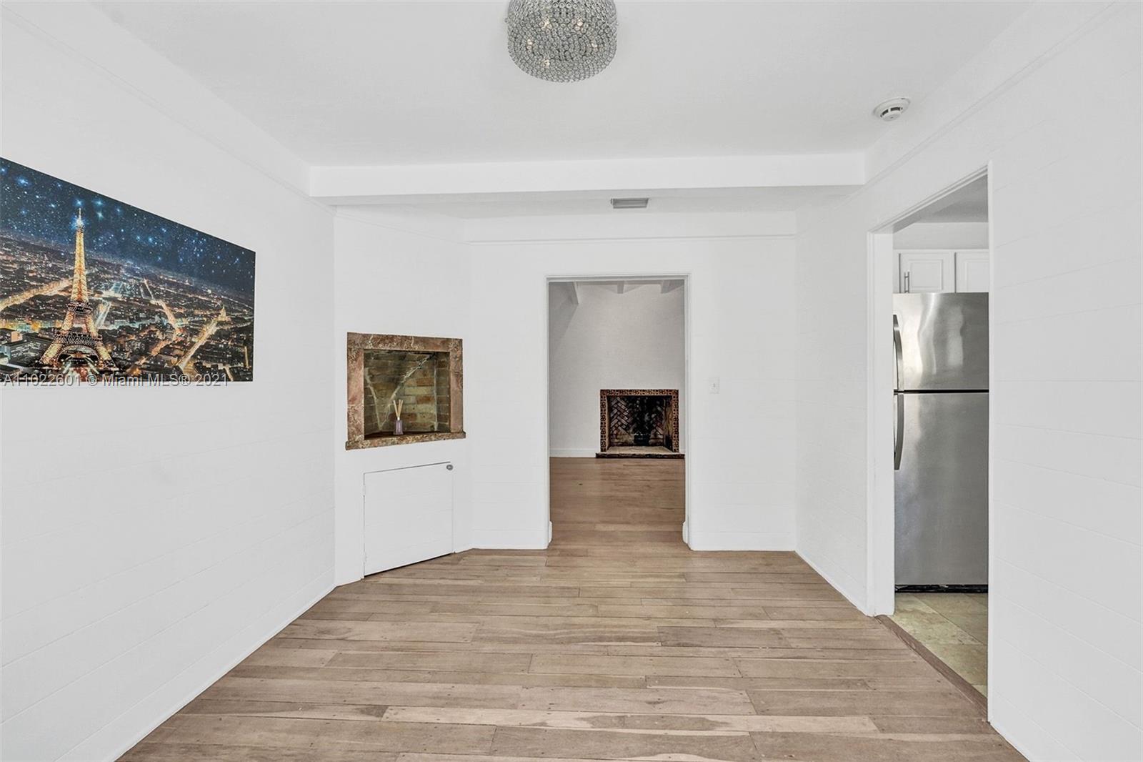 4717 Alton Road Miami Beach, FL 33140 - Photo 38 of 59 a view of a hallway with wooden floor and workspace