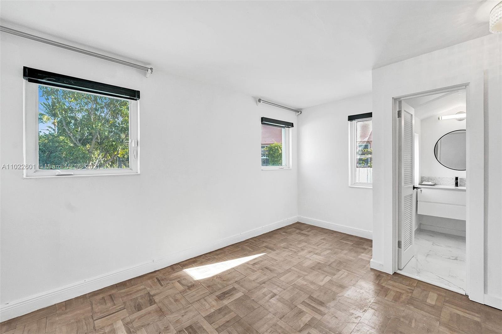 4717 Alton Road Miami Beach, FL 33140 - Photo 39 of 59 an empty room with a window and a livingroom