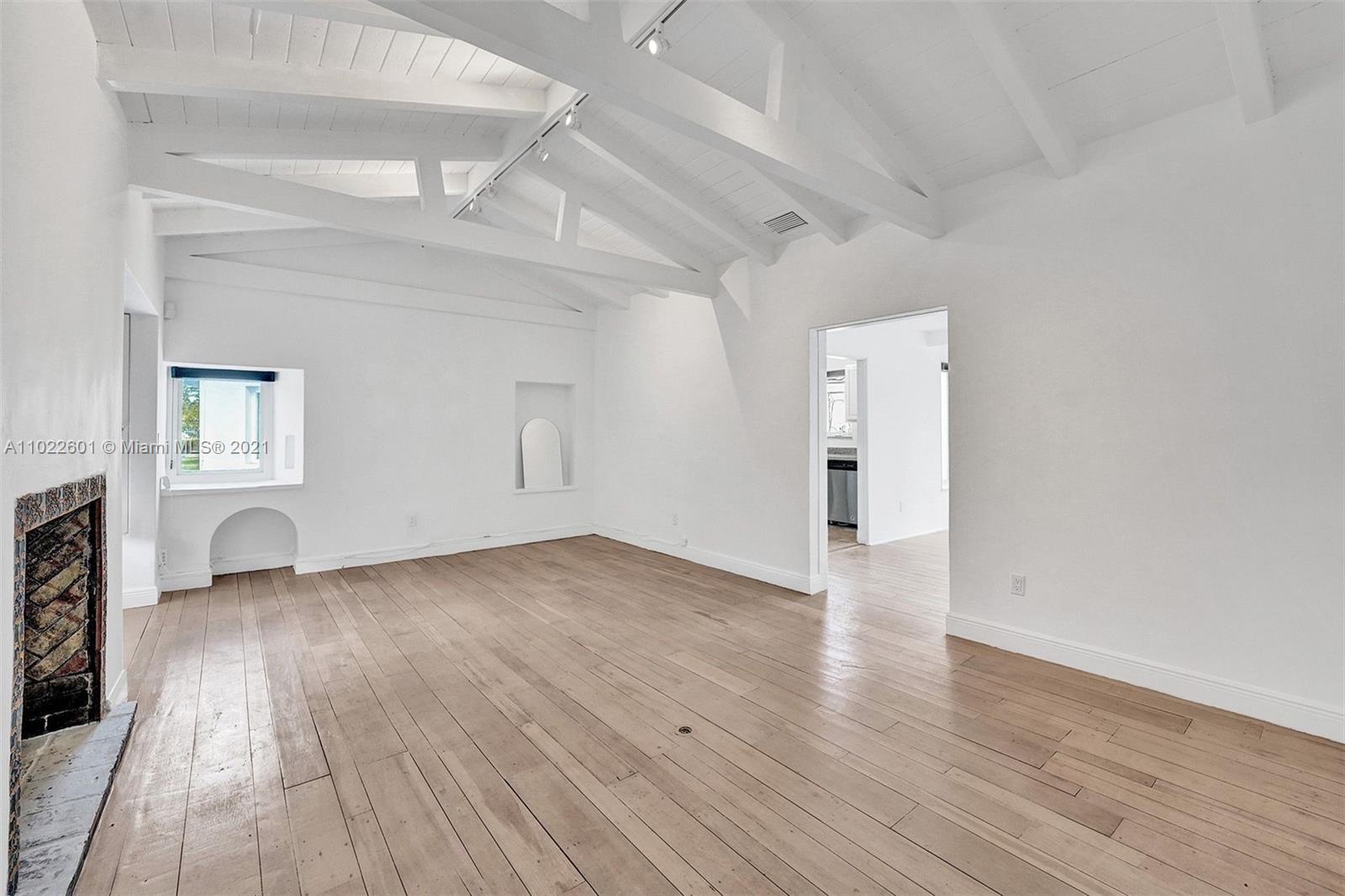 4717 Alton Road Miami Beach, FL 33140 - Photo 4 of 59 a view of a livingroom with wooden floor