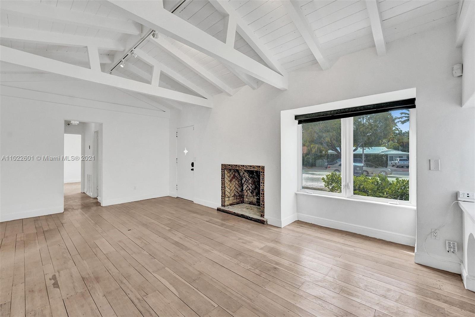 4717 Alton Road Miami Beach, FL 33140 - Photo 42 of 59 a view of an empty room with a window and wooden floor