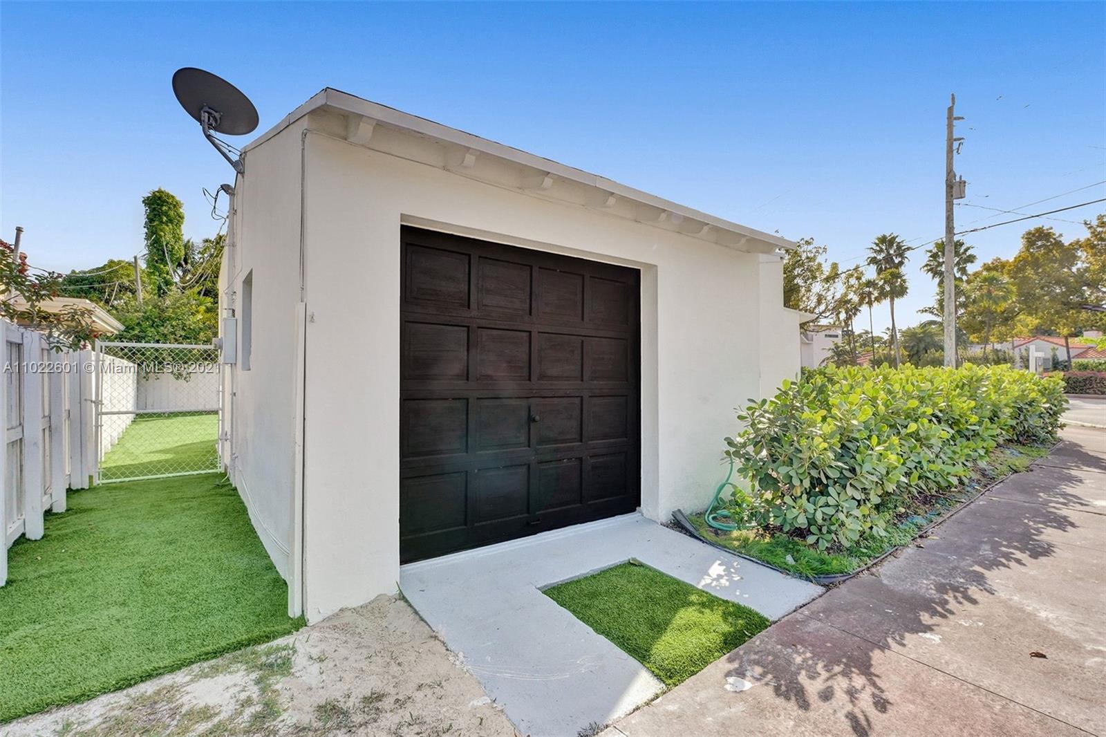 4717 Alton Road Miami Beach, FL 33140 - Photo 43 of 59 a front view of a house with a yard