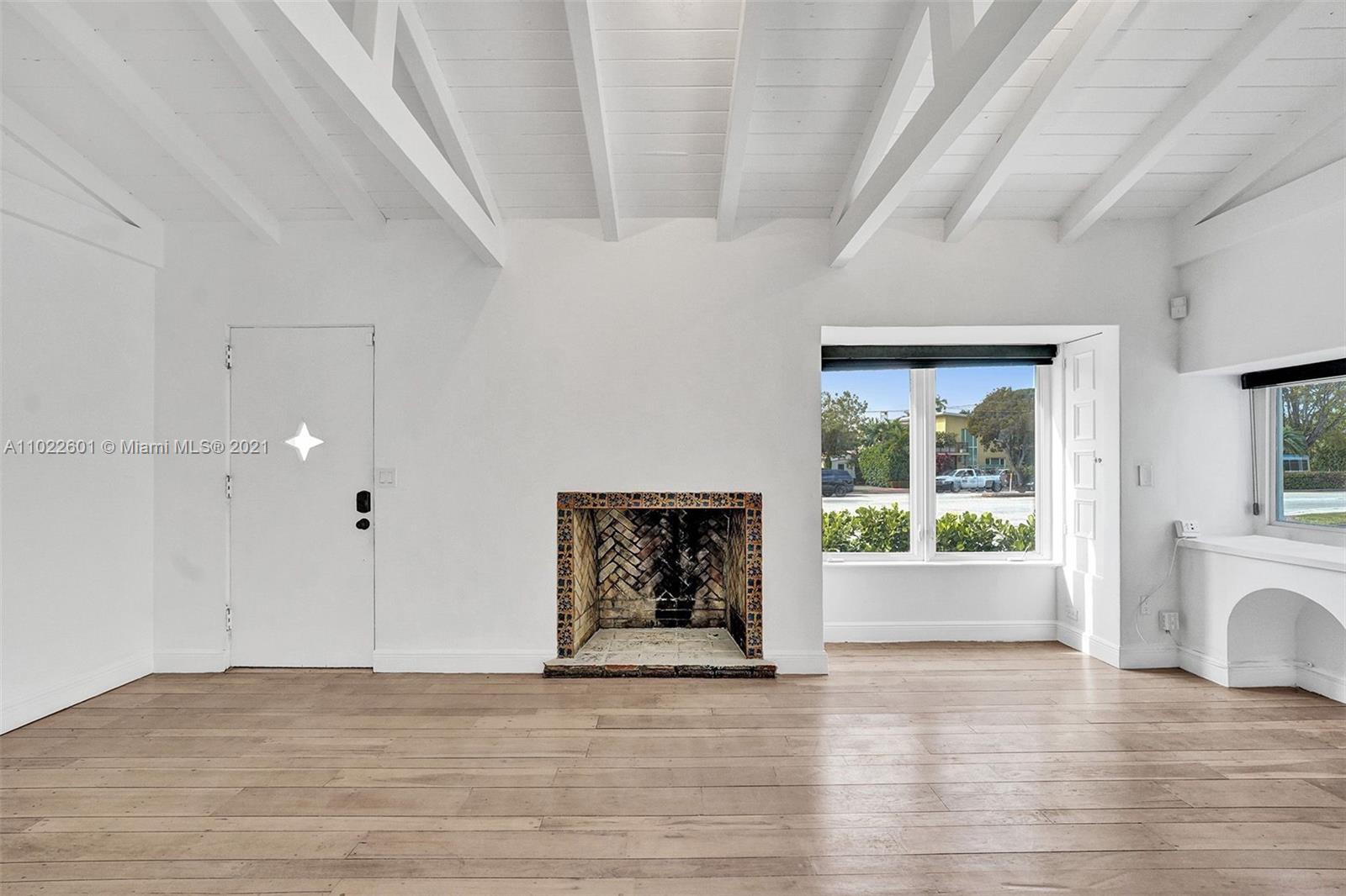 4717 Alton Road Miami Beach, FL 33140 - Photo 49 of 59 a view of an empty room with wooden floor and a window