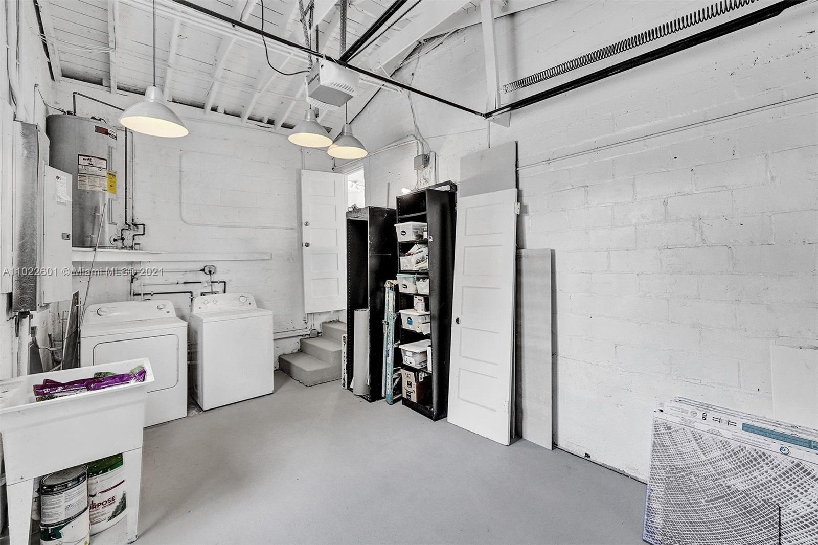 4717 Alton Road Miami Beach, FL 33140 - Photo 54 of 59 a view of storage and utility room with racks on the wall