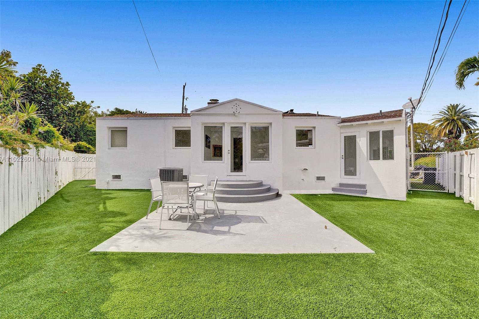 4717 Alton Road Miami Beach, FL 33140 - Photo 57 of 59 a front view of a house with a yard