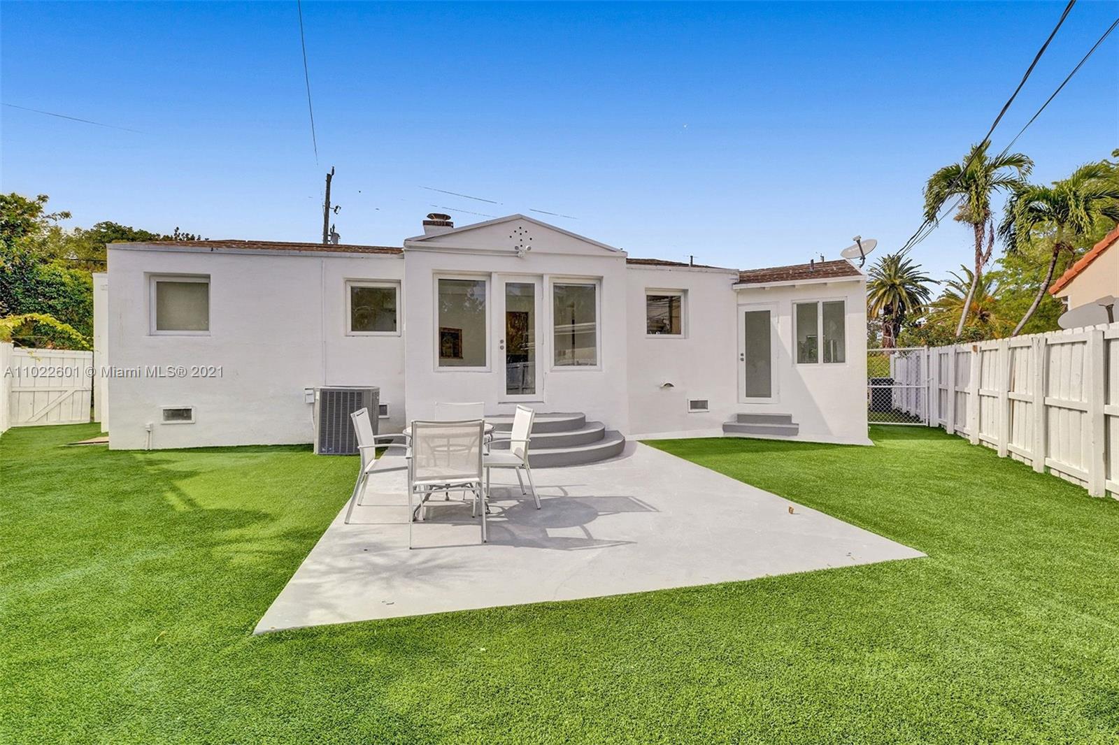 4717 Alton Road Miami Beach, FL 33140 - Photo 59 of 59 a front view of a house with a garden and yard