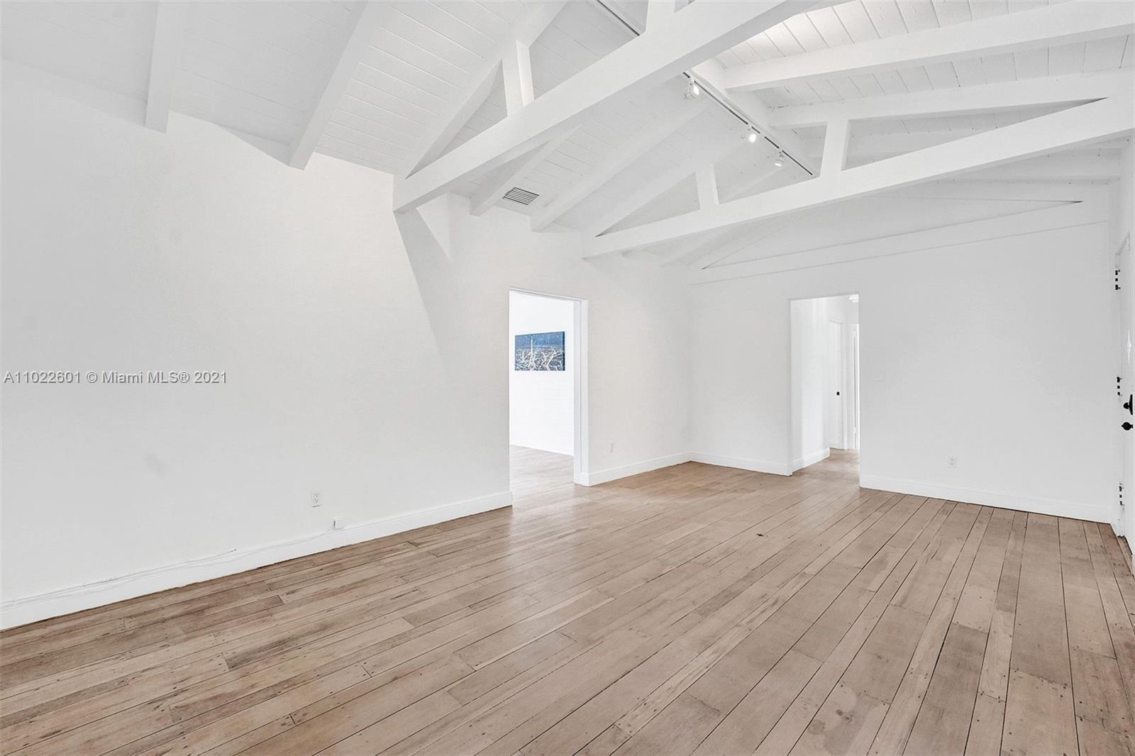 4717 Alton Road Miami Beach, FL 33140 - Photo 6 of 59 a view of an empty room with wooden floor